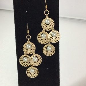 Gold dangle earrings with faux pearls.